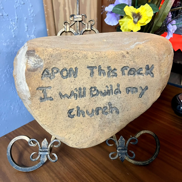 Image of a rock with "Upon the Rock I will Build My Church" scripture written on it.
