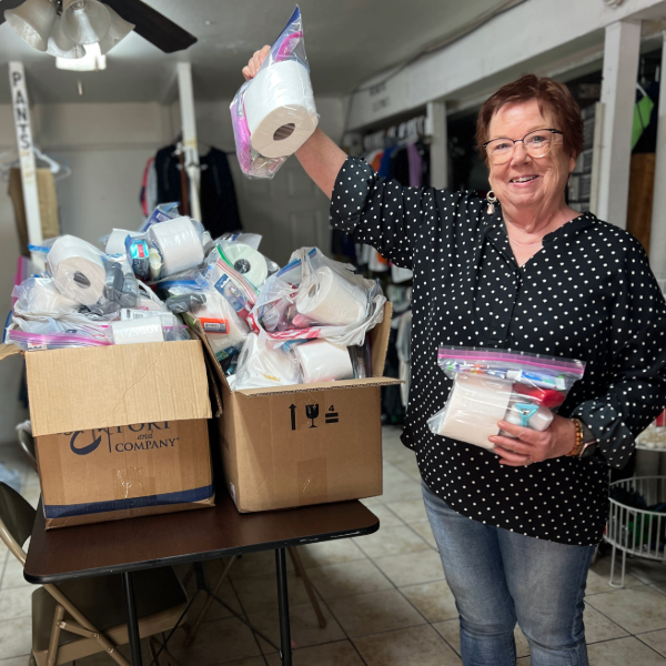 Photo of Pastor Cherryll in the clothing room with hygiene packs